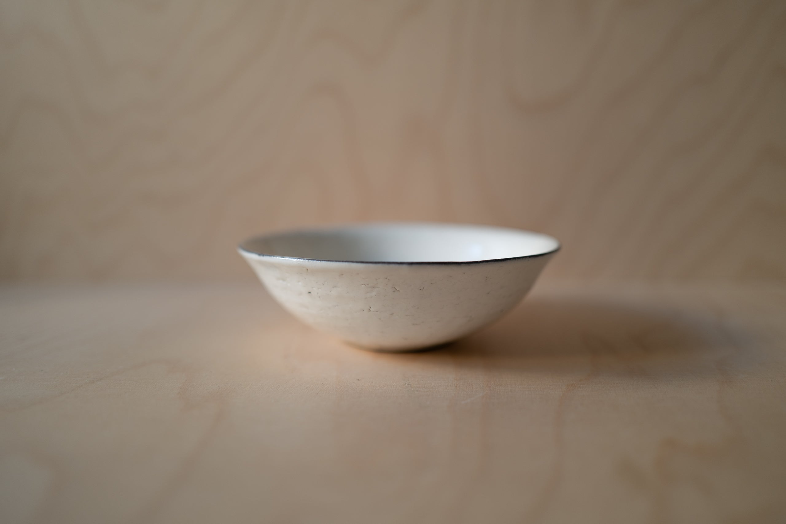 Japanese white ceramic bowl with black profile